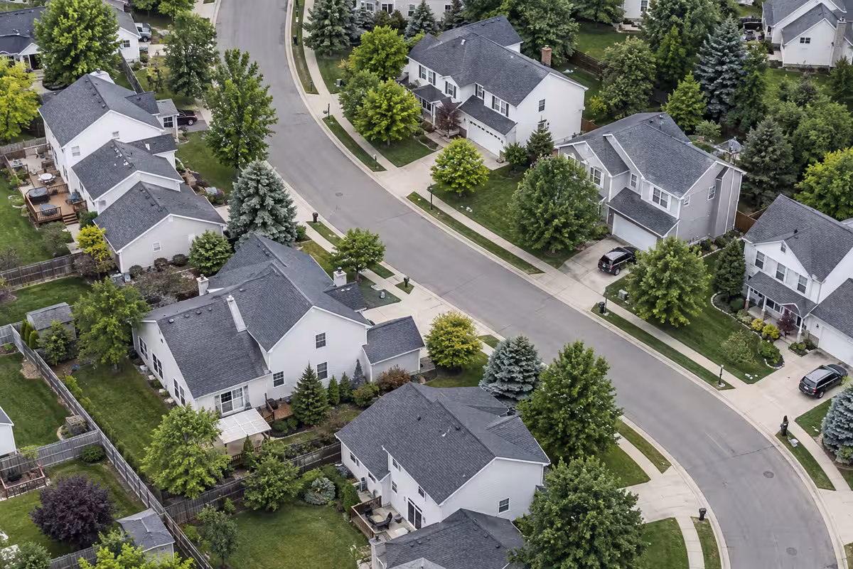 Aerial view of a suburban neighborhood with a curving street