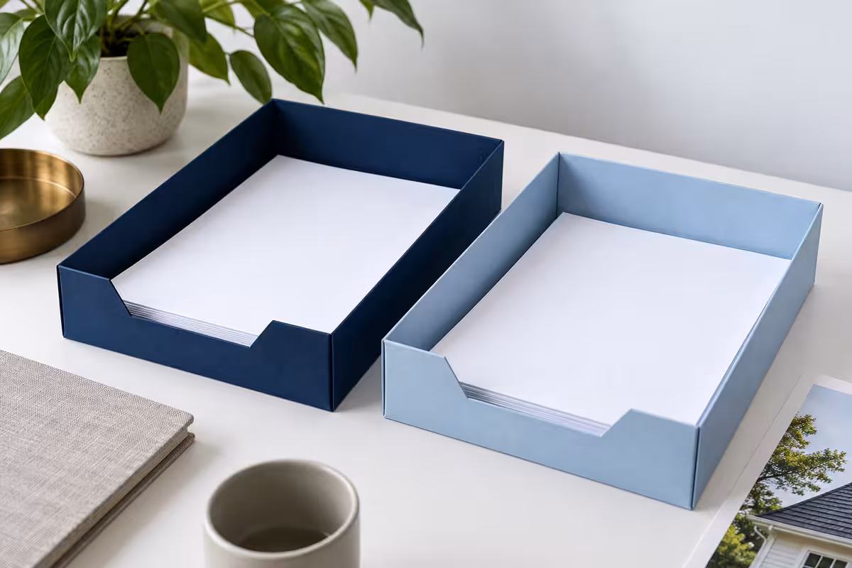 Two separate paper trays represent tax and insurance funds.